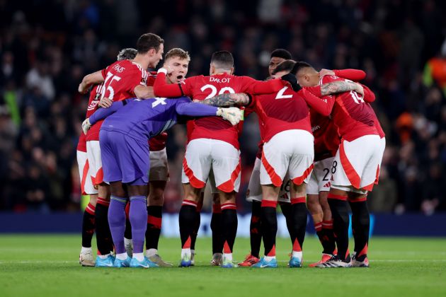 Jonny Evans joins in a pre-match huddle with his teammates.