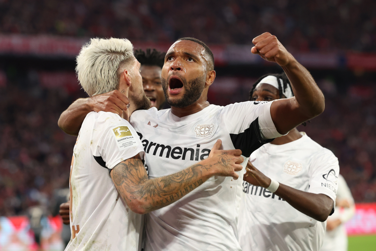 Jonathan Tah celebrates with his Leverkusen teammates.
