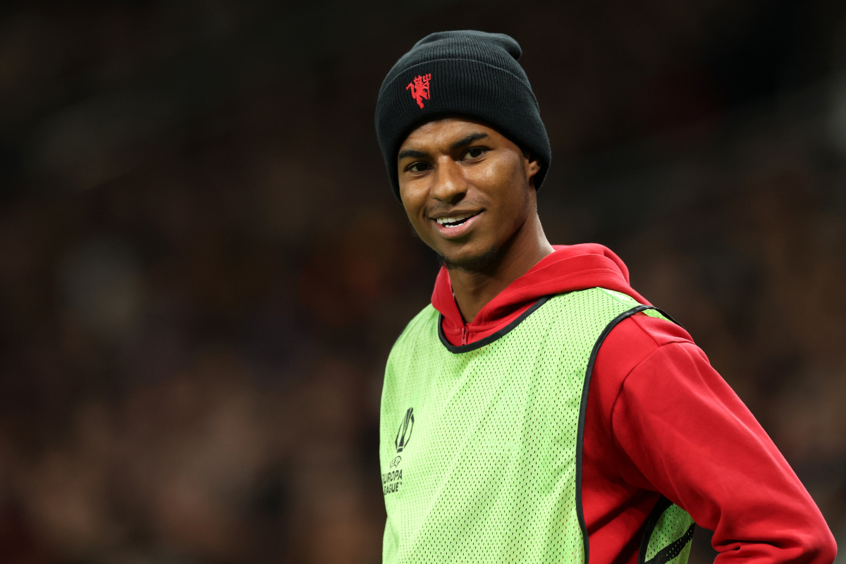 Marcus Rashford warms up on the touchline.