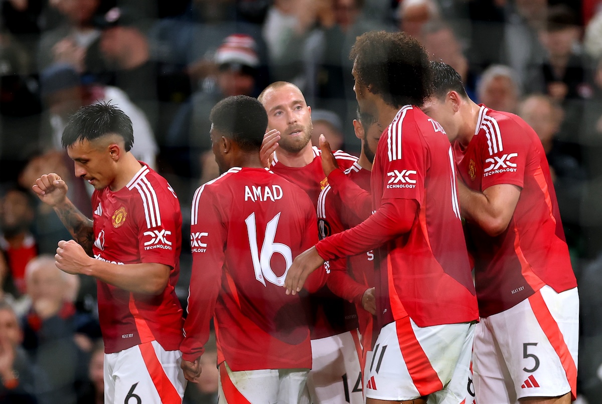 Manchester United players celebrate scoring a goal in the Europa League