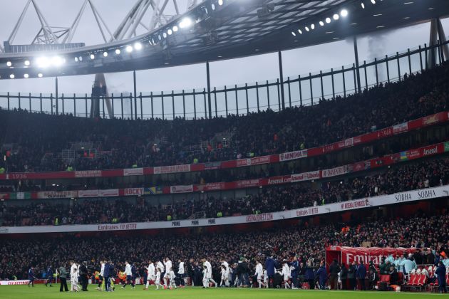 United and Arsenal players walk out at the Emirates Stadium prior to kick-off.