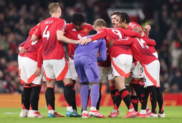 Manchester United players huddle ahead of kick-off at Old Trafford.