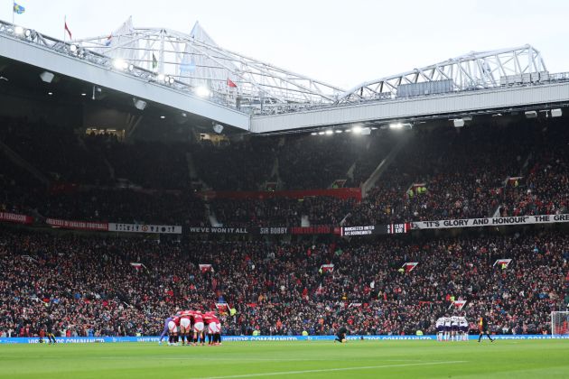 Manchester United players huddle ahead of kick-off at Old Trafford.