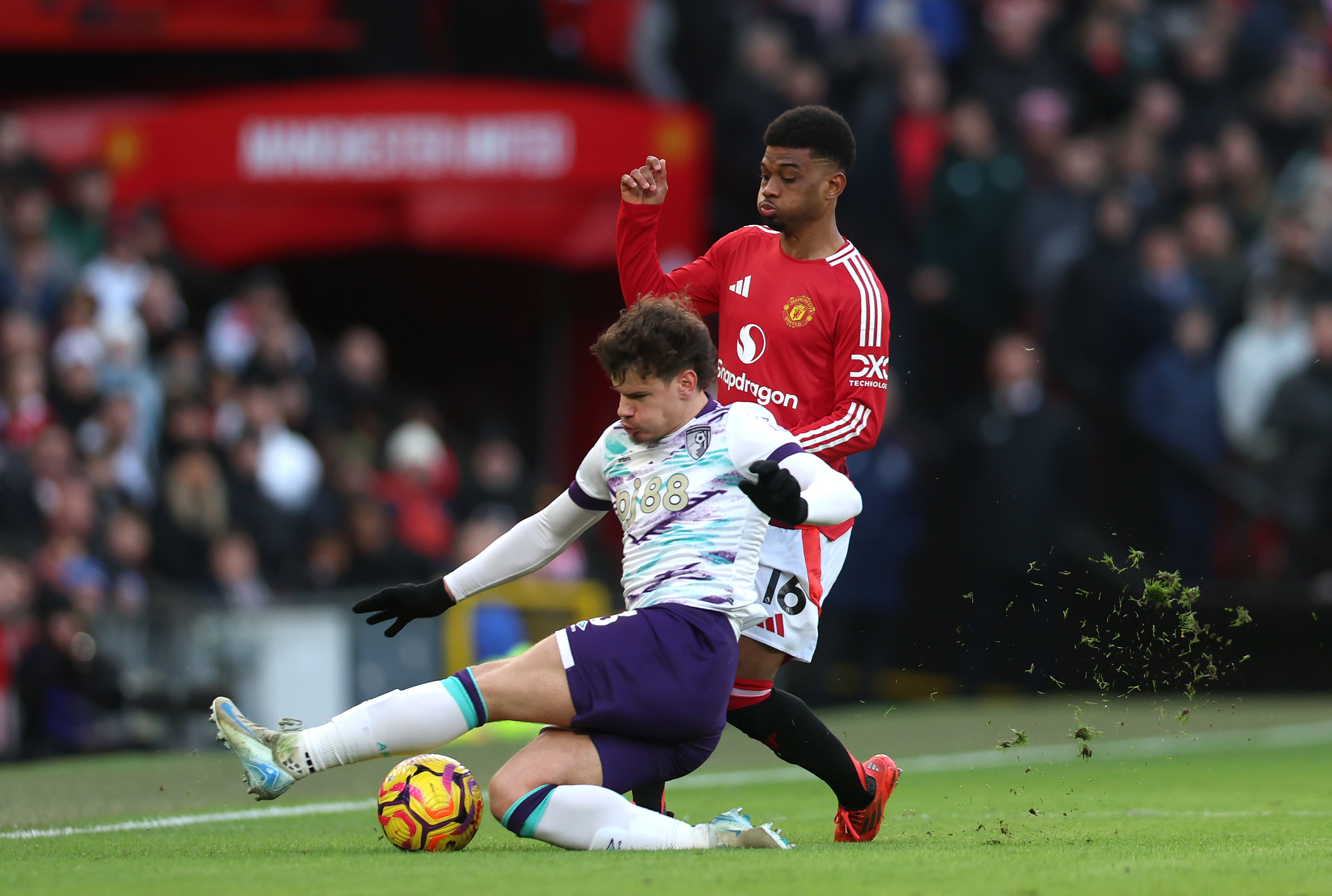 Milos Kerkez tackles Amad Diallo while in action at Old Trafford.