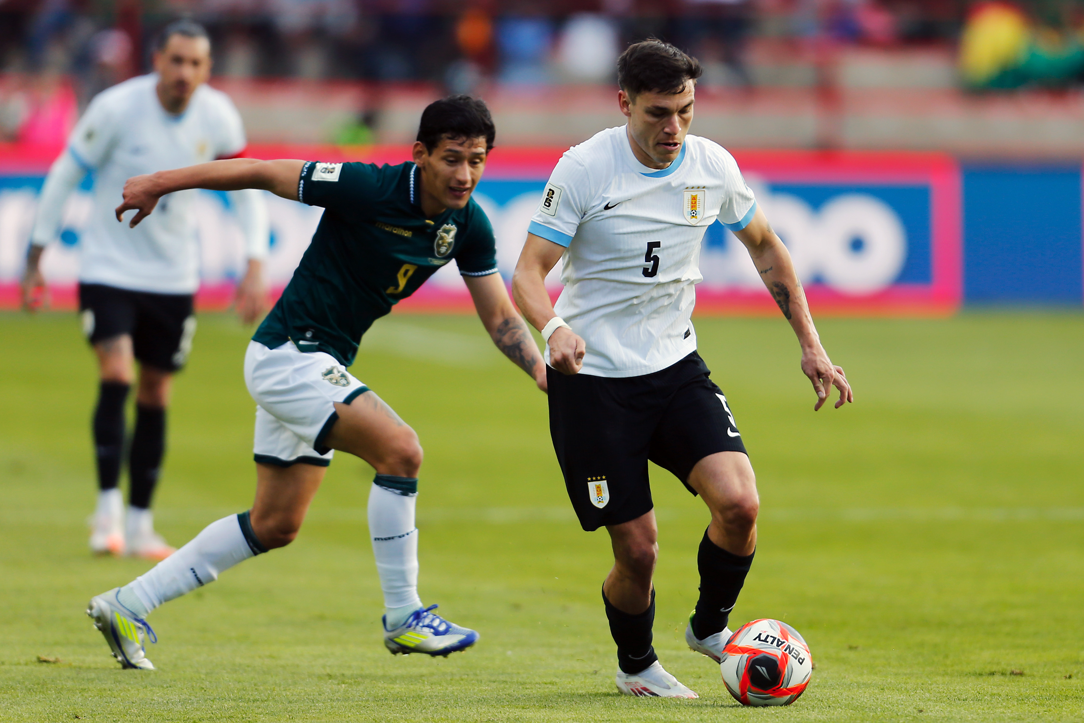 Manuel Ugarte carries the ball while in action for Uruguay against Bolivia.