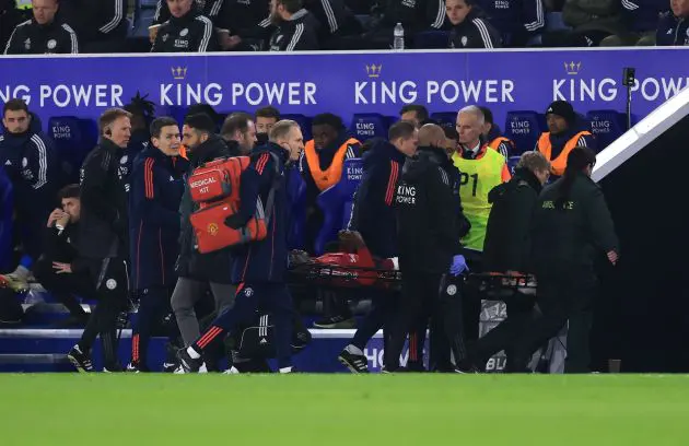 Ayden Heaven stretched off the pitch after suffering injury against Leicester