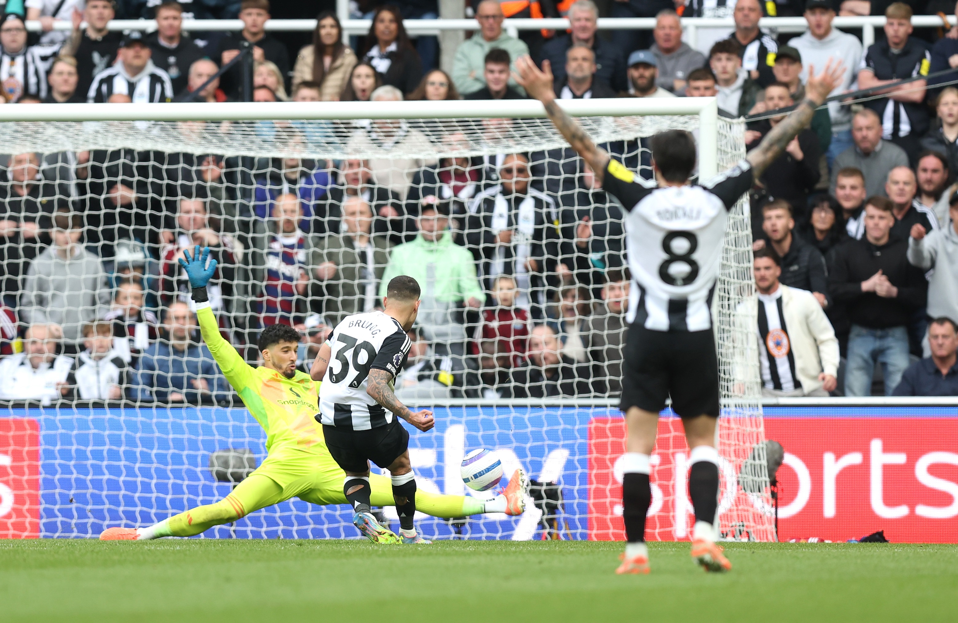Altay Bayindir stretches his leg to reach a Bruno Guimaraes shot.