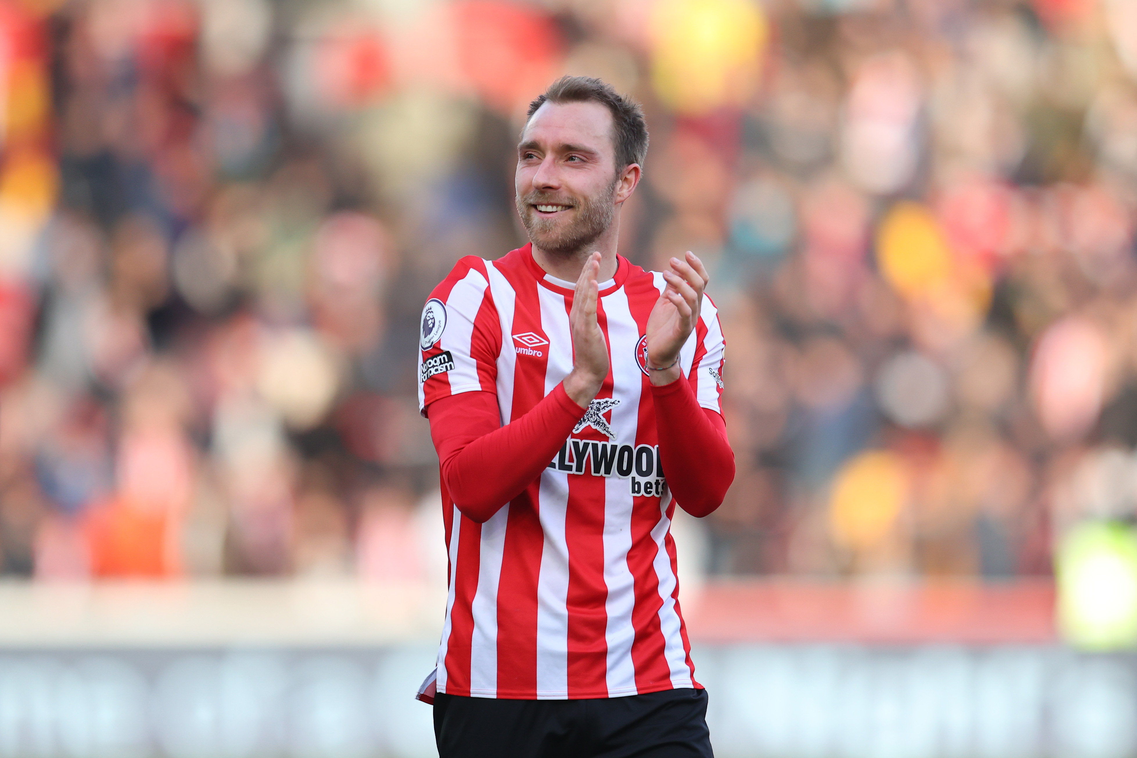 Christian Eriksen applauds the Brentford fans.