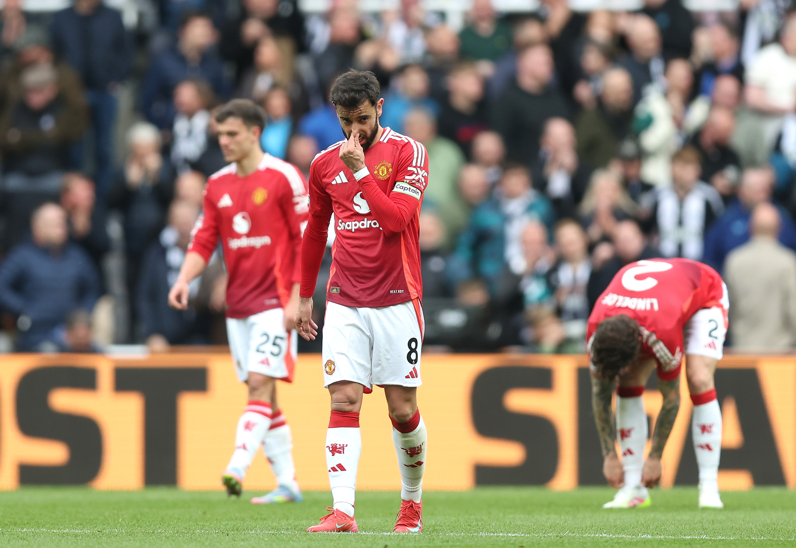 Bruno Fernandes of Manchester United looks dejected after Harvey Barnes of Newcastle United (not pictured) scores his team's third goal during the Premier League match between Newcastle United FC and Manchester United FC at St James' Park on April 13, 2025 in Newcastle upon Tyne, England.