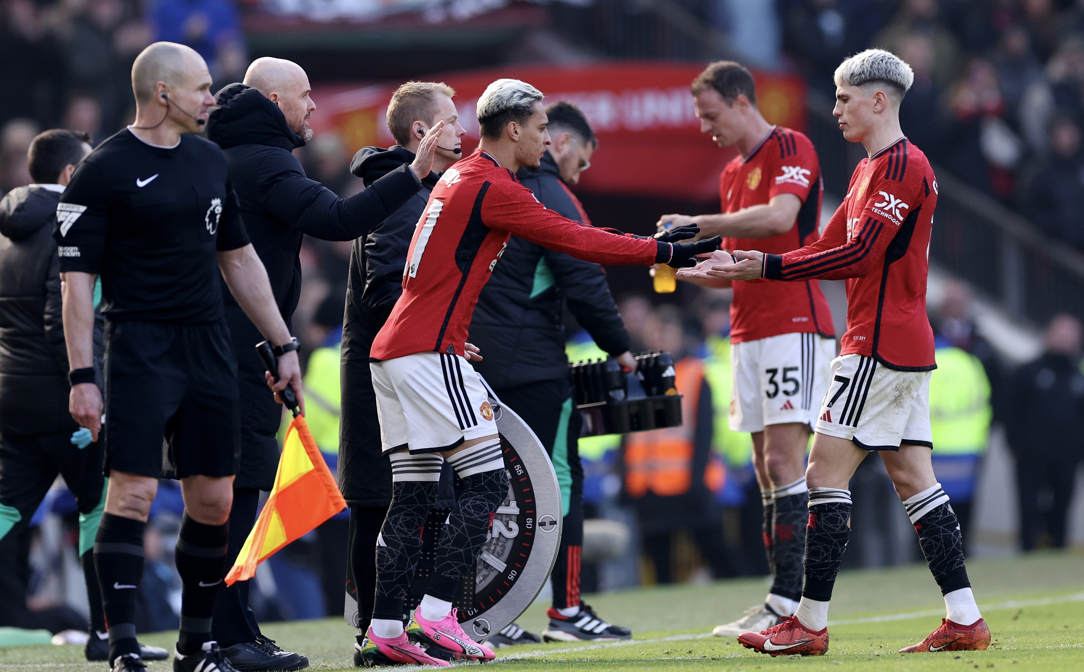 MANCHESTER, ENGLAND - MARCH 09: Alejandro Garnacho of Manchester United is substituted off for Antony of Manchester United during the Premier League match between Manchester United and Everton FC at Old Trafford on March 09, 2024 in Manchester, England. (Photo by Alex Livesey/Getty Images)