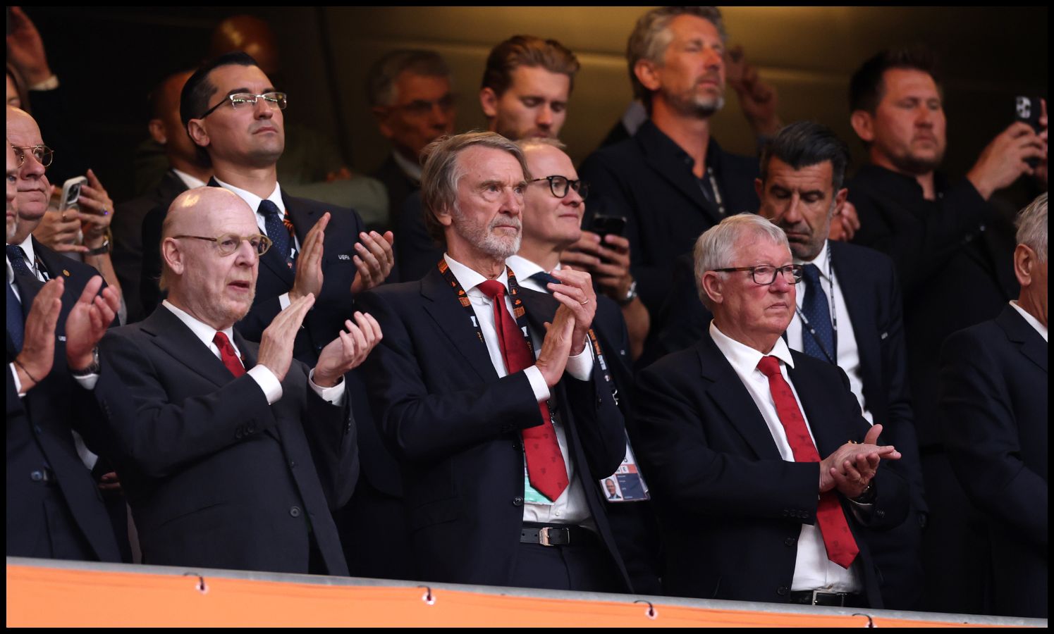 Sir Jim Ratcliffe and Sir Alex Ferguson clap in the stands.
