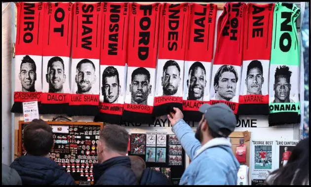 Scarves outside Old Trafford show the faces of several Man United players.