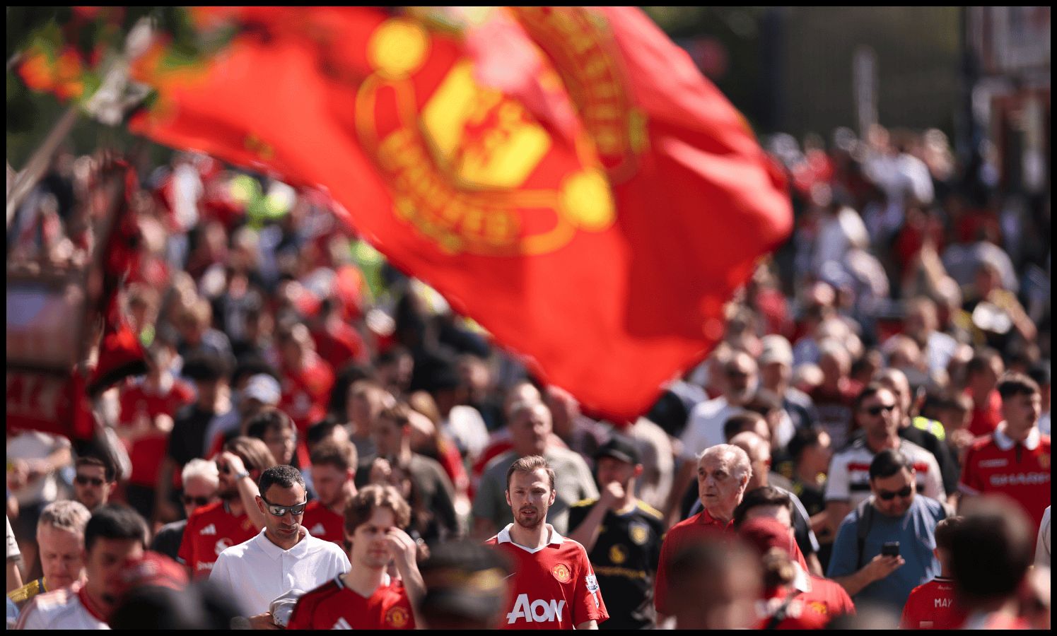Man United fans make their way to Old Trafford on matchday.