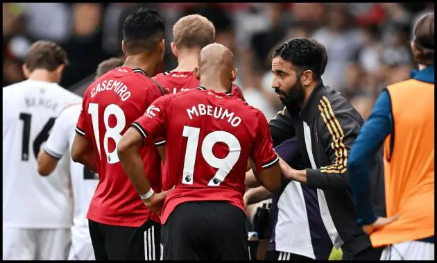 Ruben Amorim talks to Casemiro and Bryan Mbeumo on the touchline.