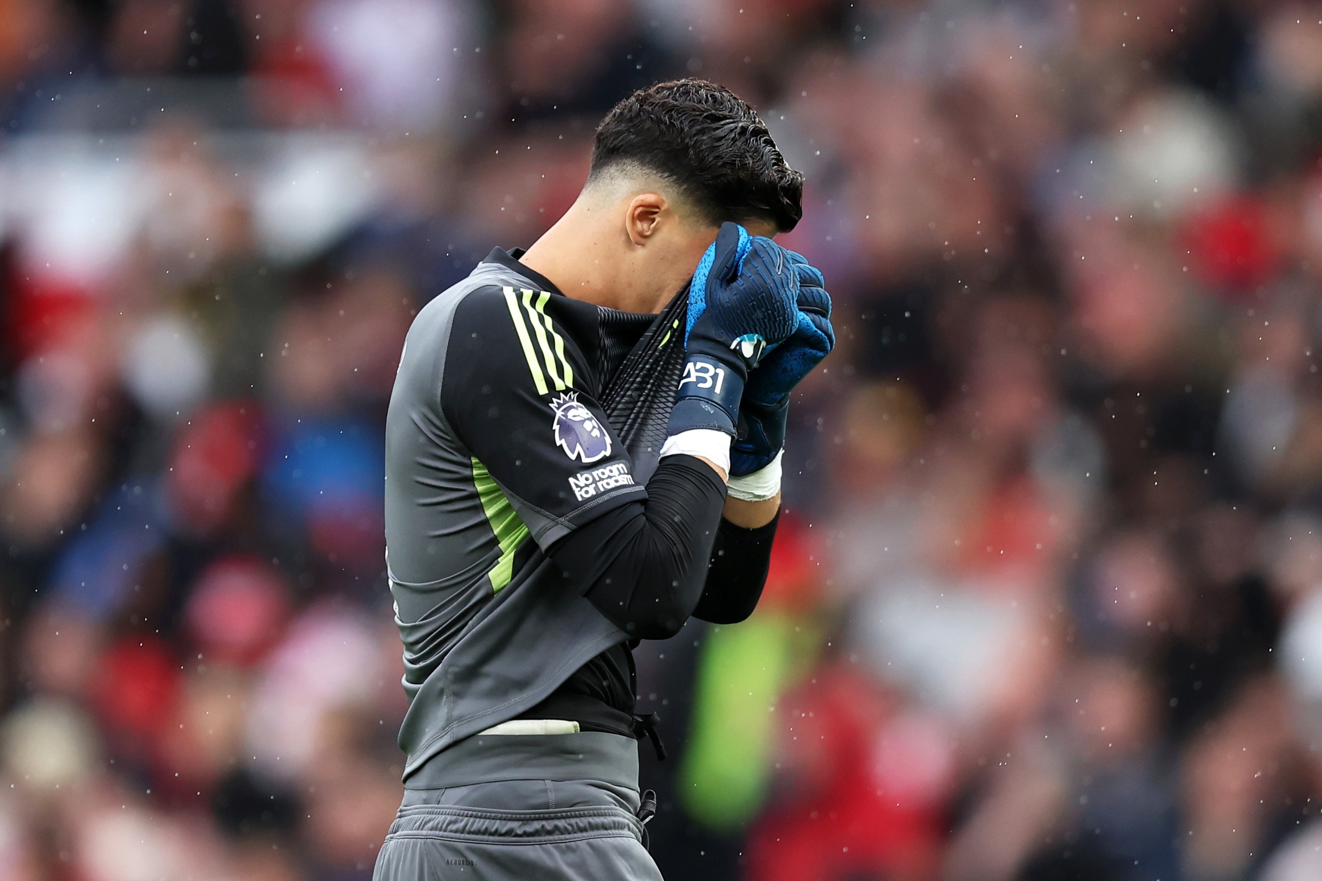 Altay Bayindir buries his face in his shirt in disappointment.