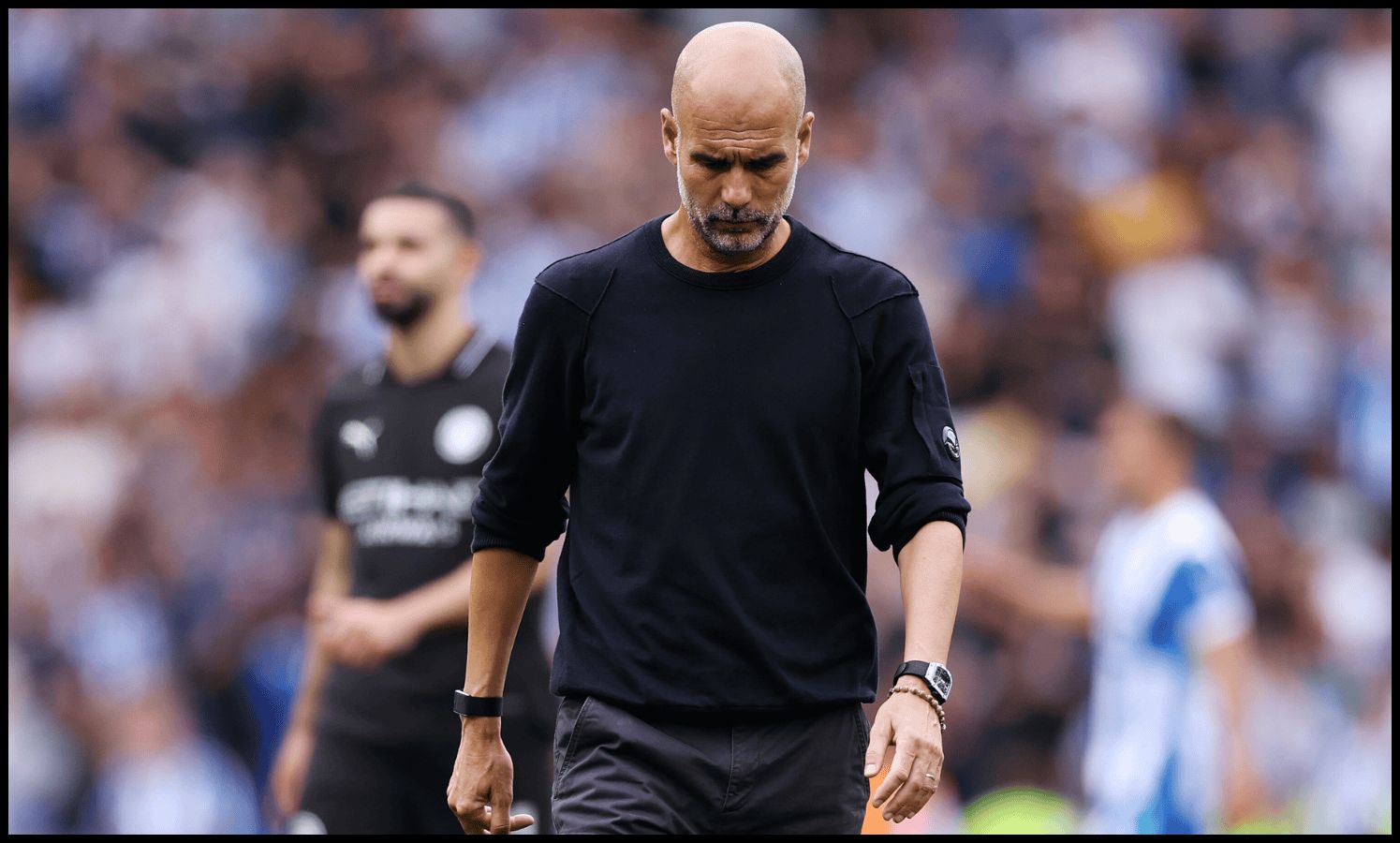 Pep Guardiola looks dejected after Man City lose to Brighton.