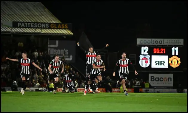 Grimsby players celebrate beating Man Utd