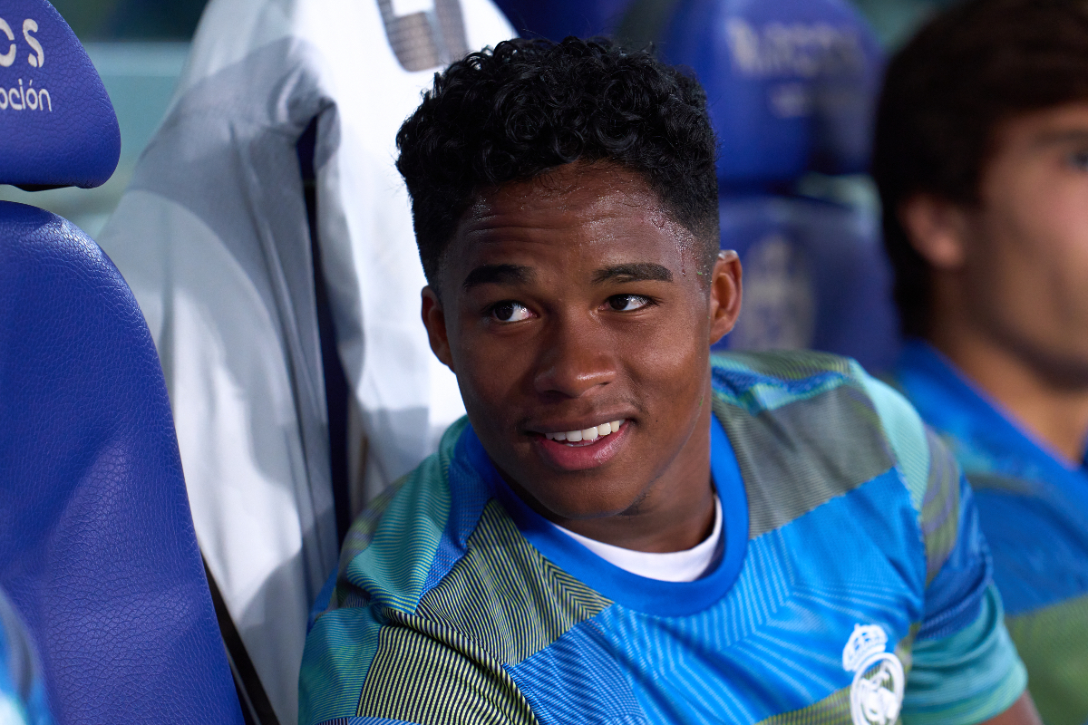 Endrick smiles while on the bench for Real Madrid.