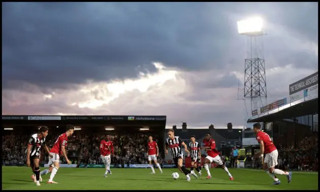Man United and Grimsby players in action at Blundell Park.