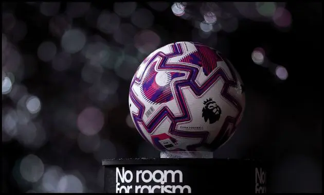 A Premier League match ball on top of a ‘No room for racism’ stand.