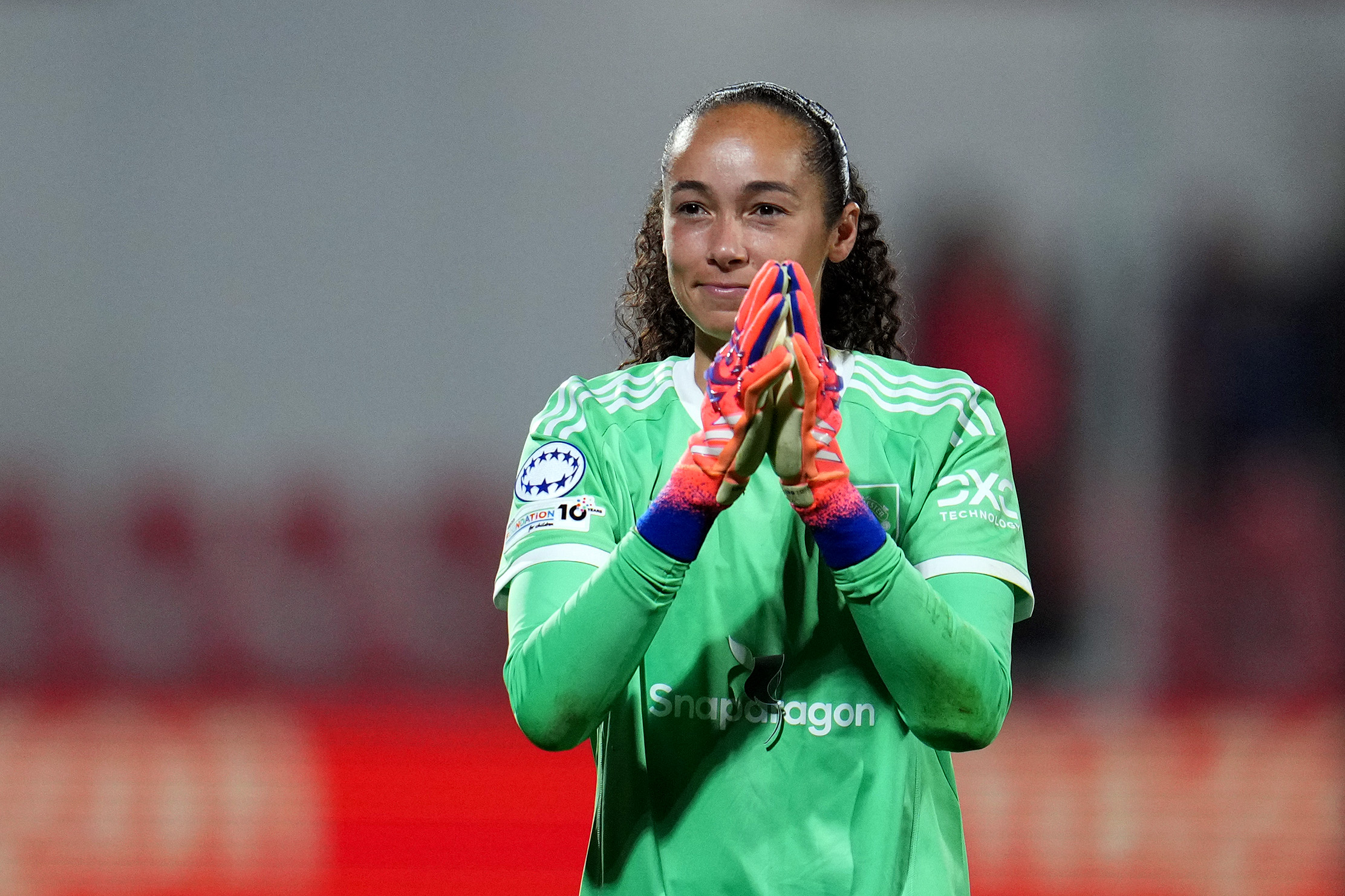 Phallon Tullis-Joyce applauds the Man United fans.