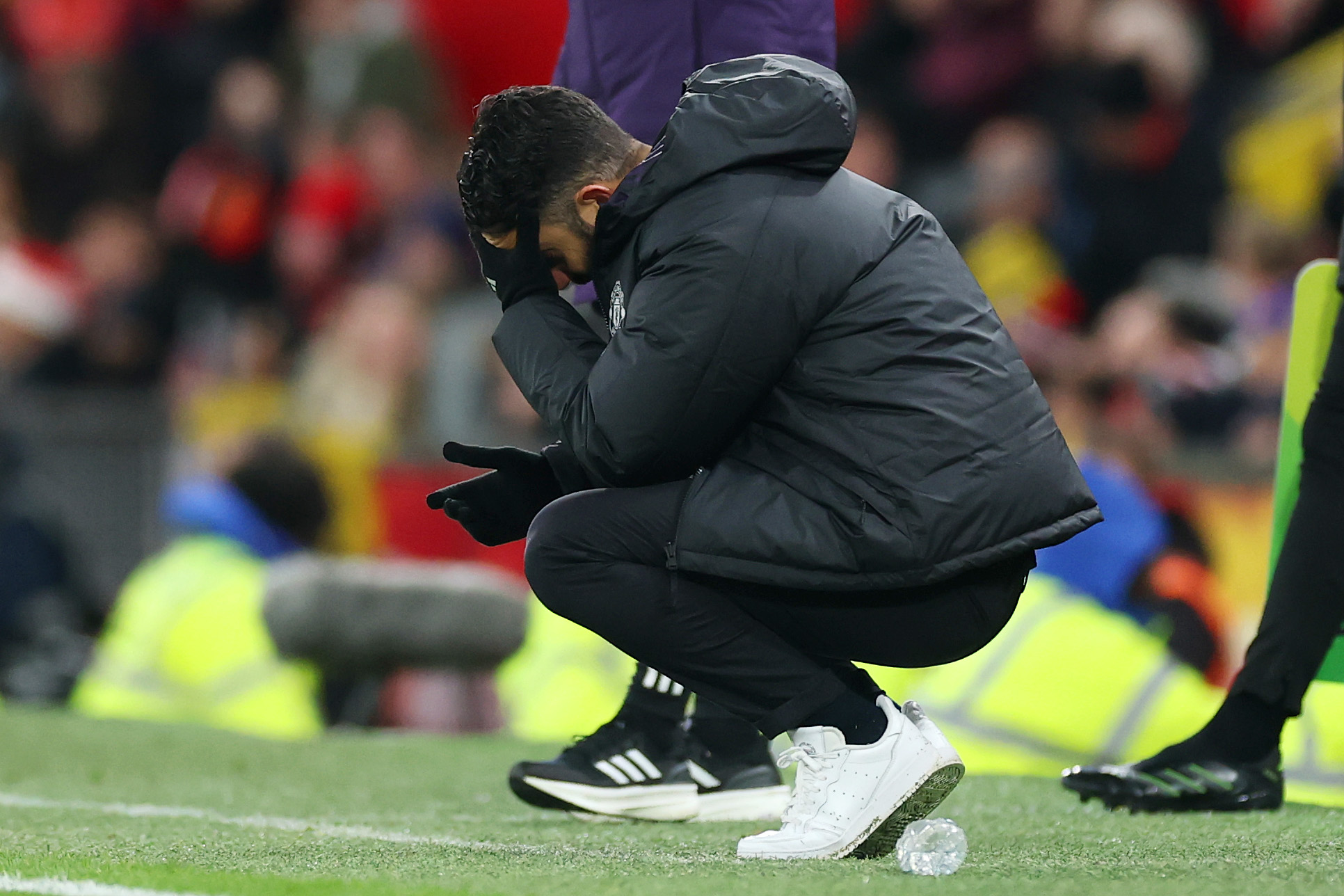 Ruben Amorim looks distressed as he crouches on the touchline.