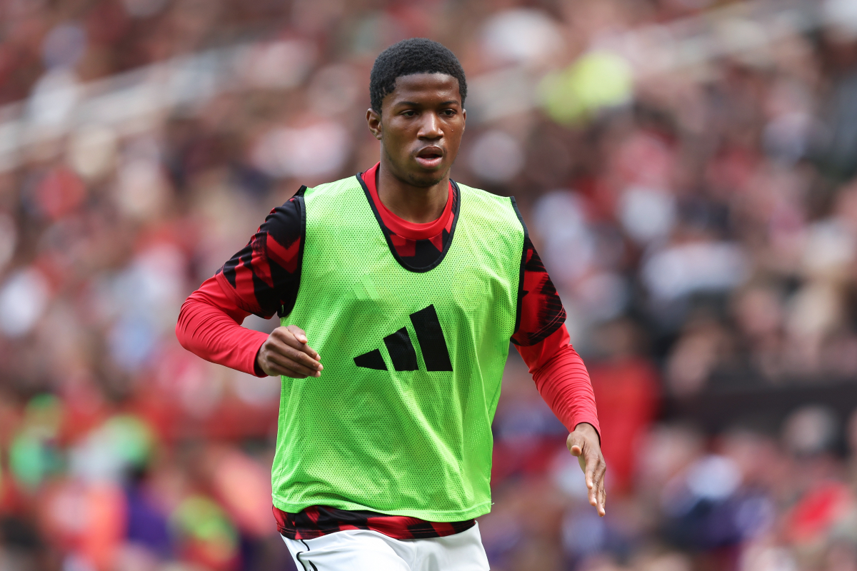 Chido Obi warms up on the touchline at Old Trafford.
