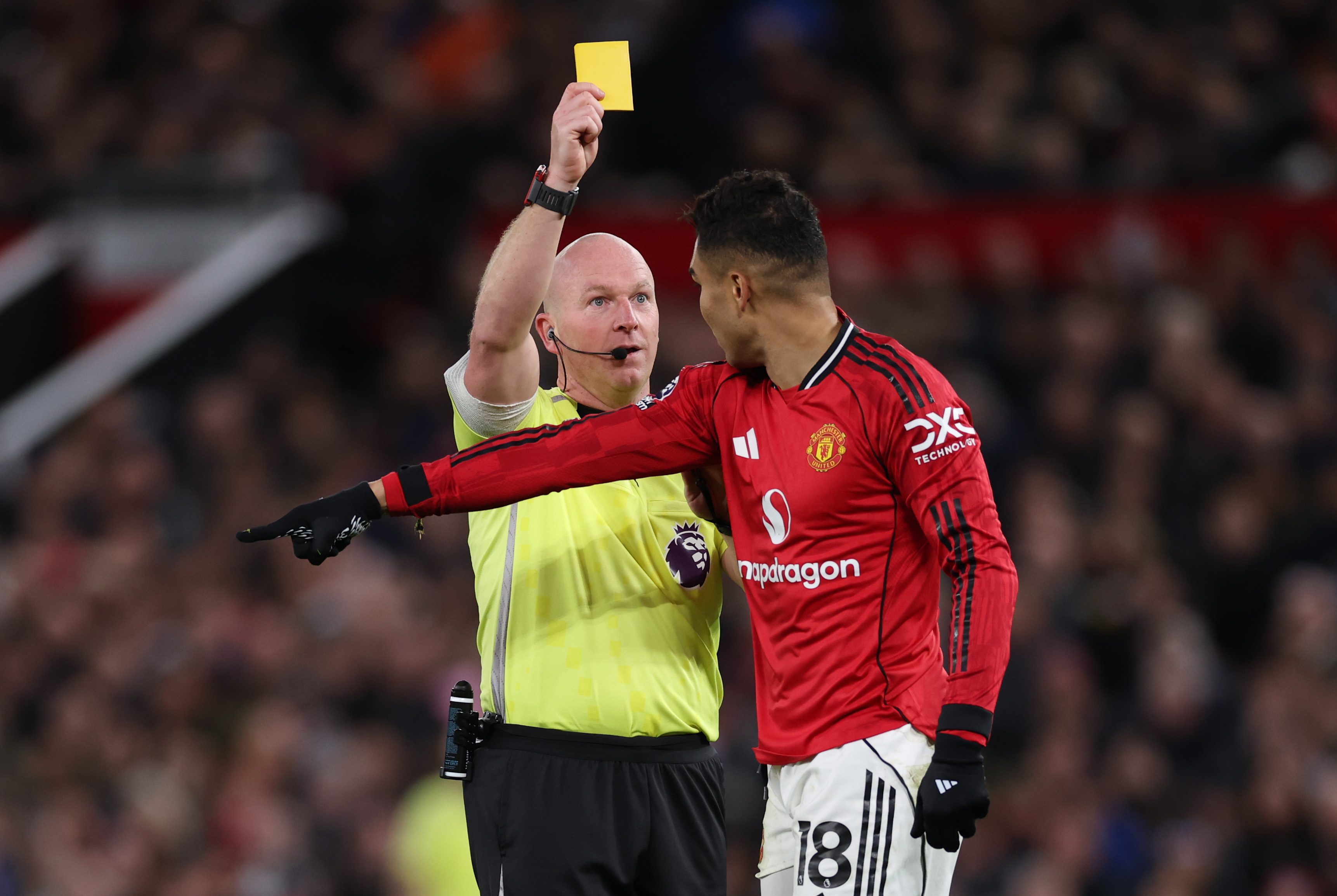 Casemiro is shown a yellow card by Simon Hooper.