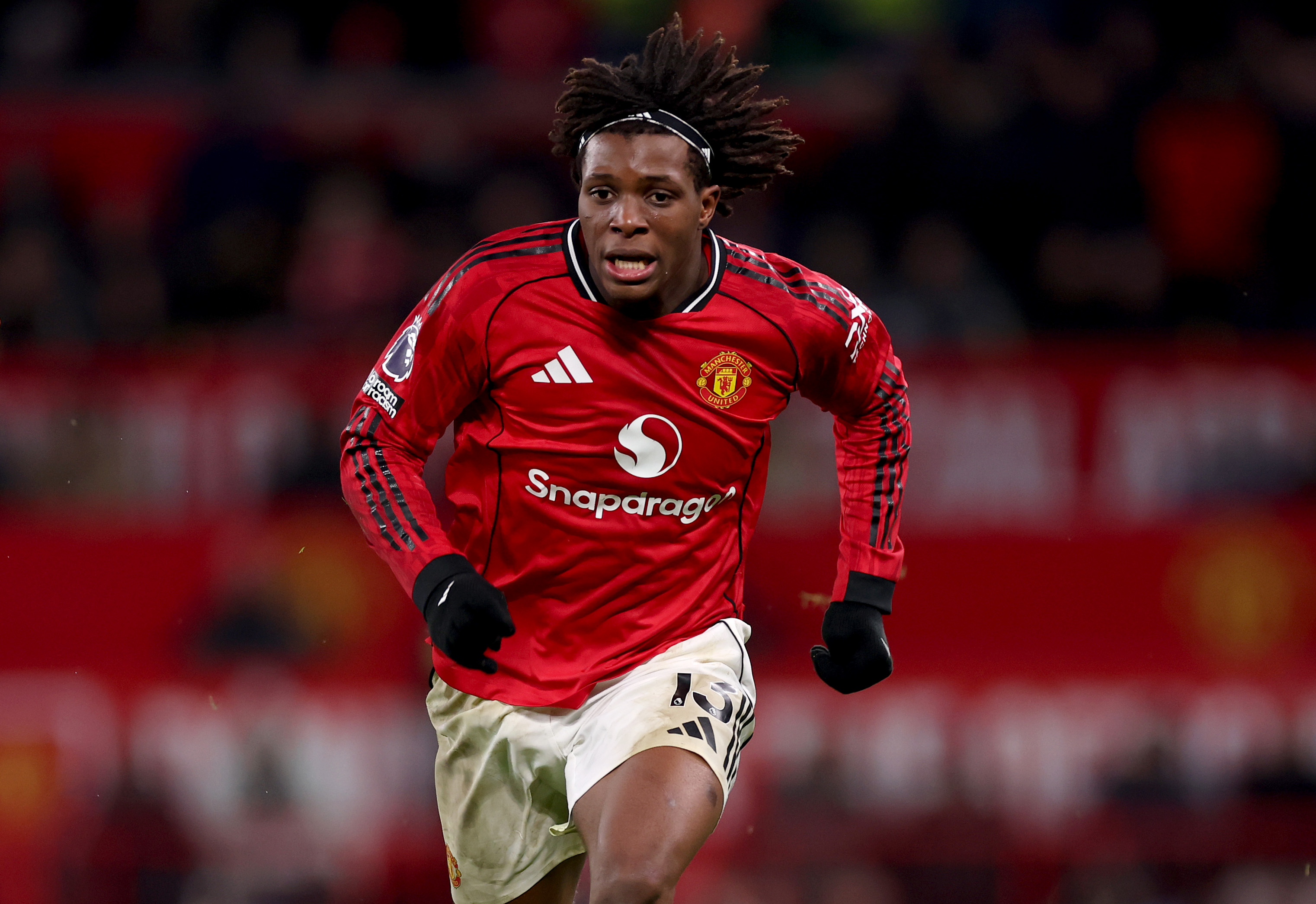 Patrick Dorgu chases the ball while in action for Man United.