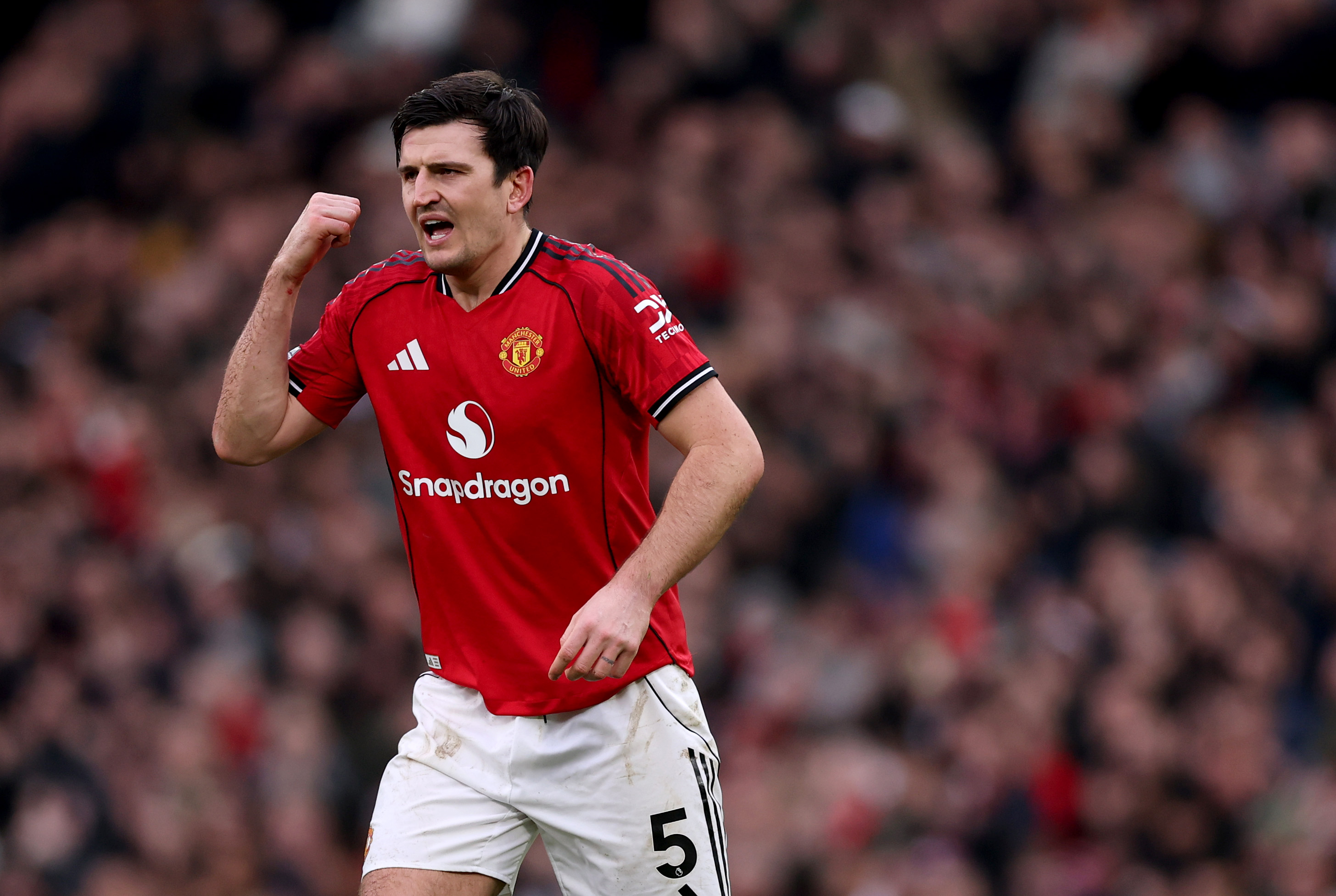 Harry Maguire gestures while in action for Man United vs Man City.