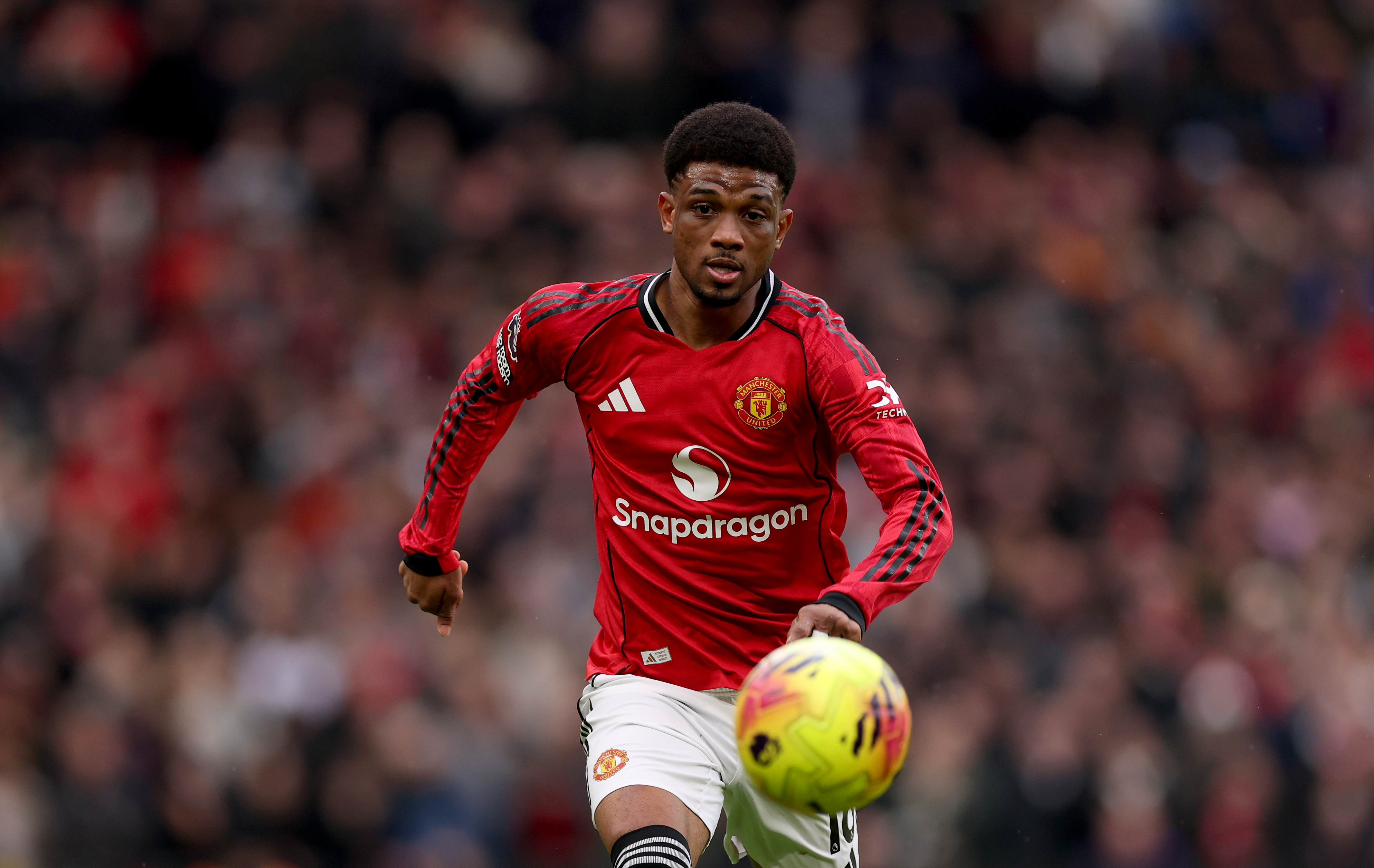 Amad Diallo chases the ball while in action for Man United vs Man City.