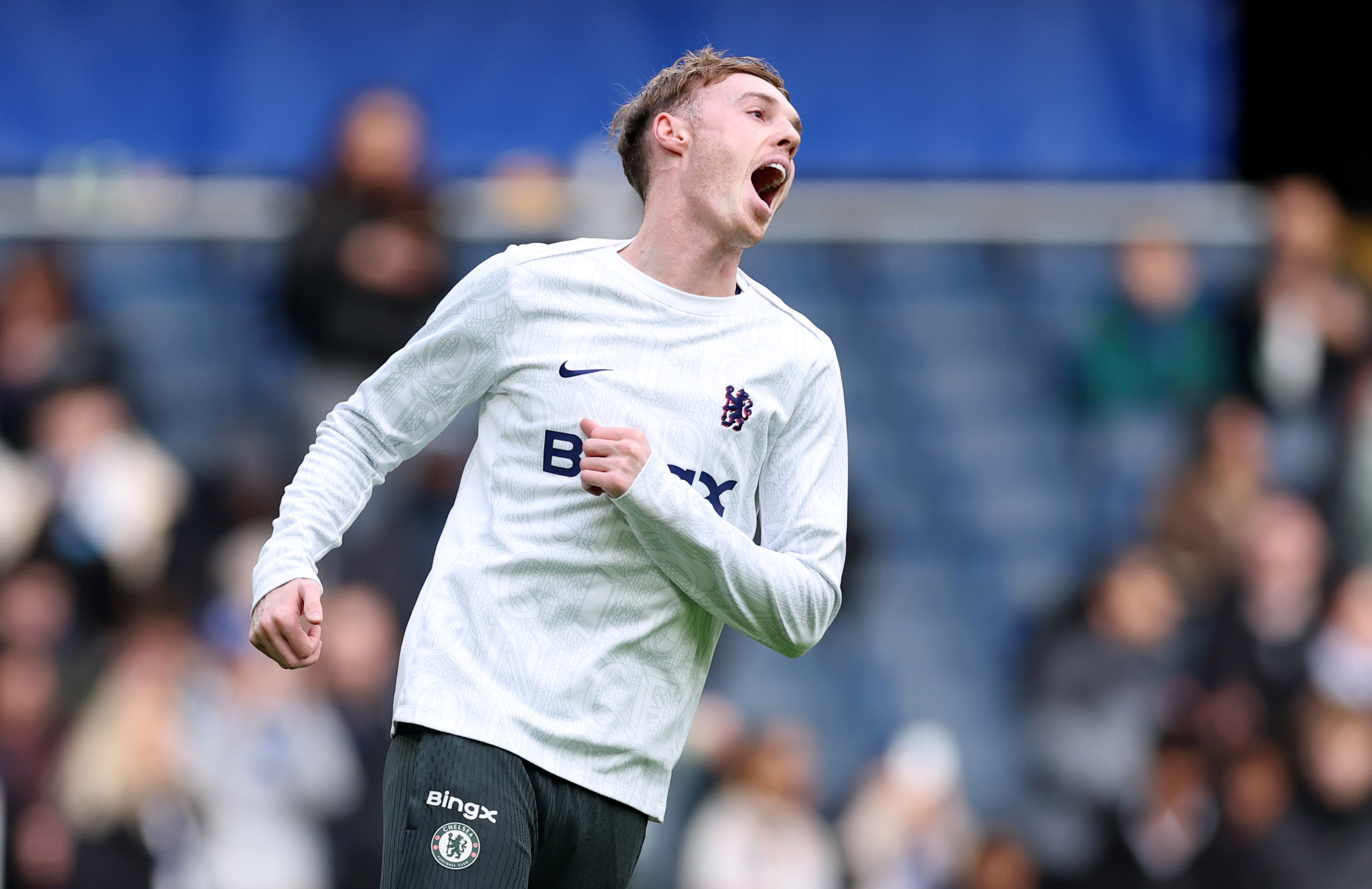 Cole Palmer reacts while warming up for Chelsea.