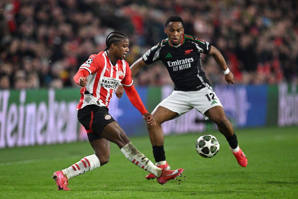 Tyrell Malacia plays the ball while under pressure from Arsenal’s Jurrien Timber.