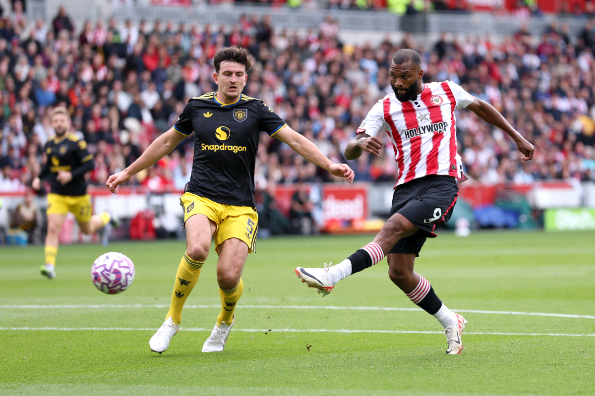 Igor Thiago shoots and scores while under pressure from Harry Maguire.