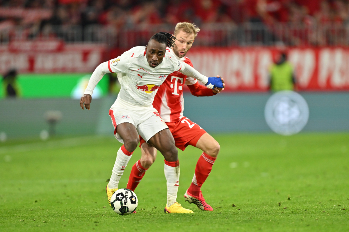MUNICH, GERMANY - FEBRUARY 11: Yan Diomande of RB Leipzig and Konrad Laimer of FC Bayern München compete for the ball during the DFB Cup Quarter Final match between FC Bayern München and RB Leipzig at Allianz Arena on February 11, 2026 in Munich, Germany.