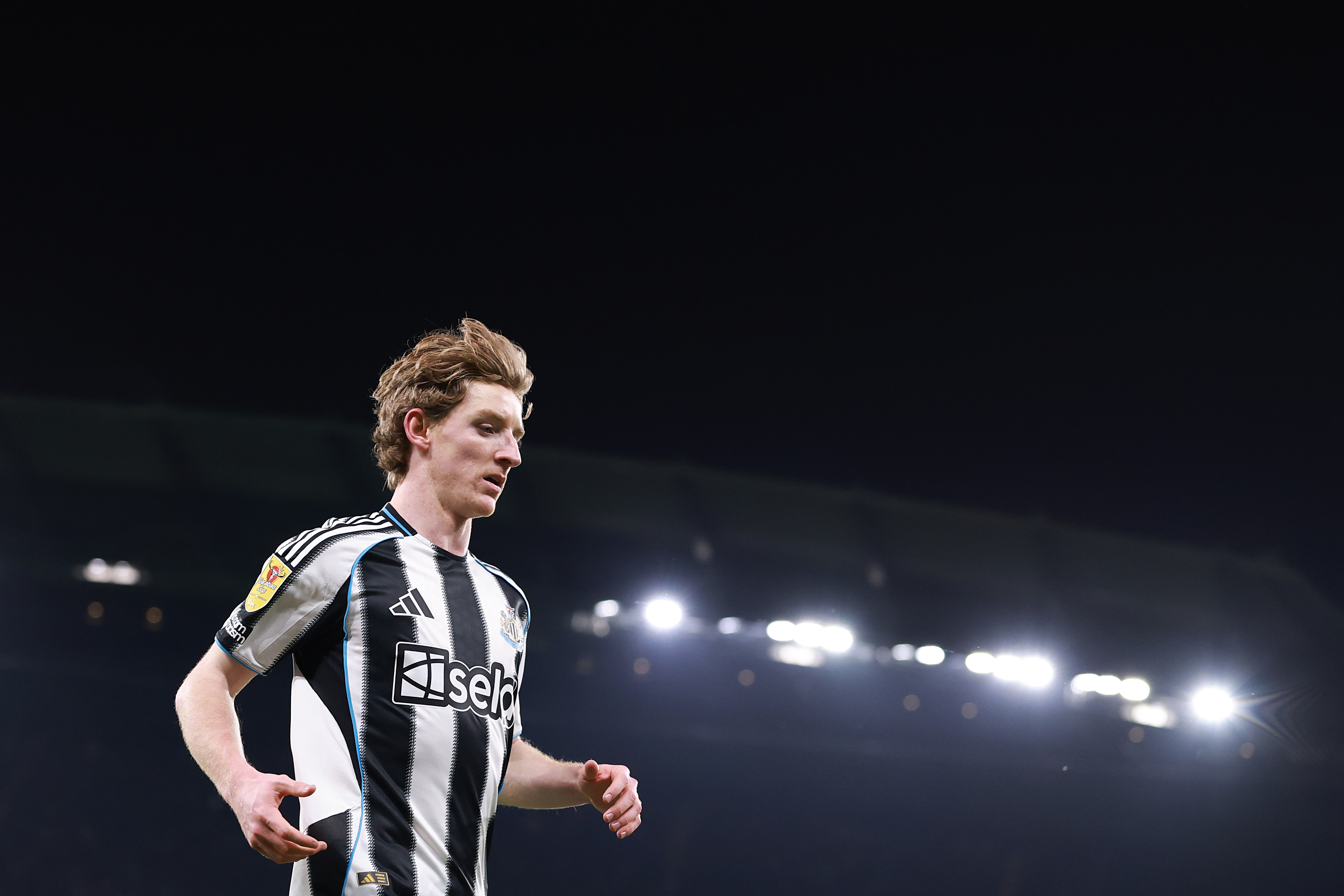 Anthony Gordon looks down while in action for Newcastle.