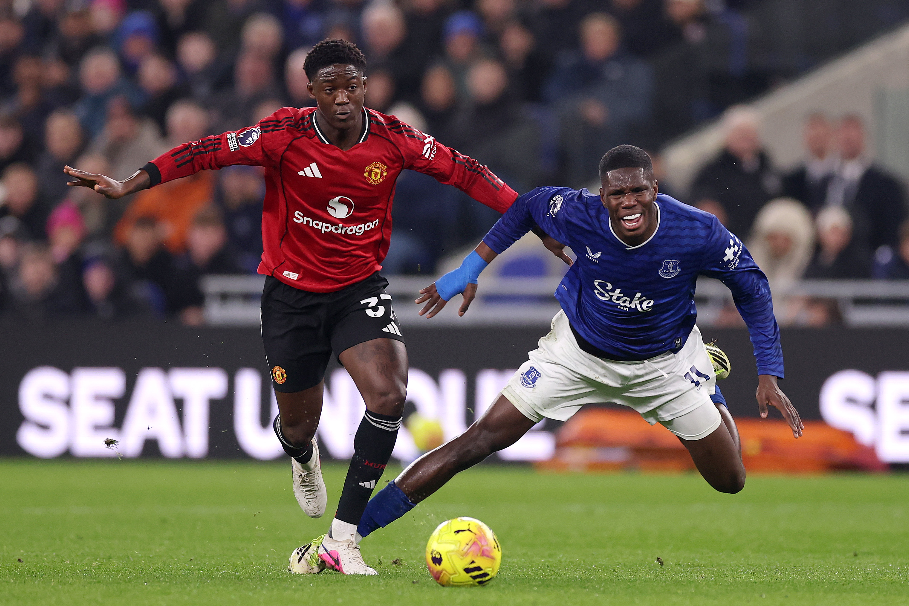 Thierno Barry goes down under the challenge of Kobbie Mainoo.