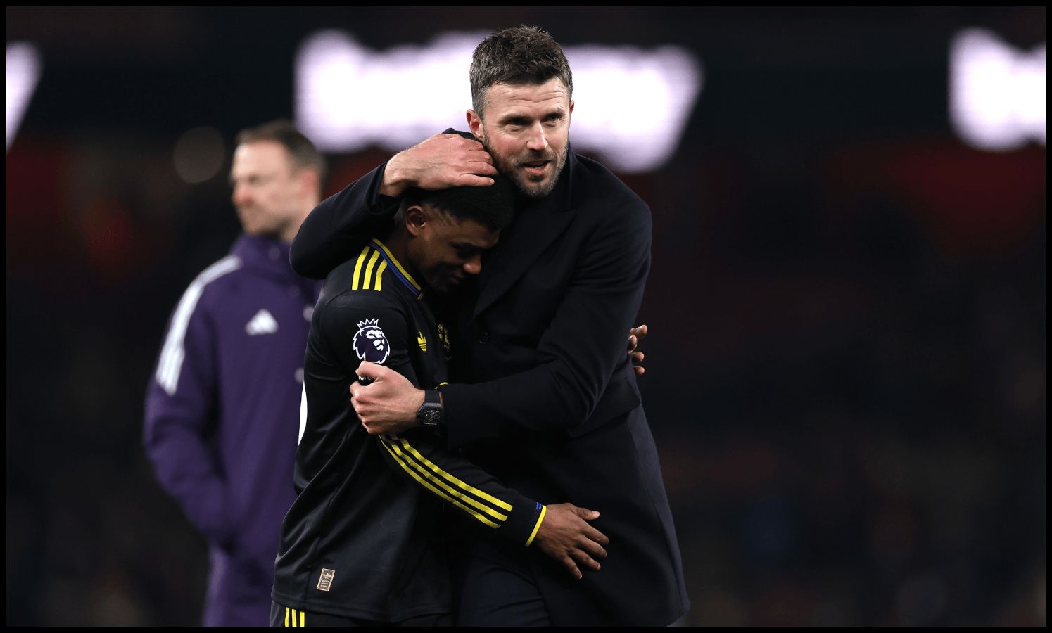 Michael Carrick embraces Amad Diallo after Man United’s win over Arsenal.