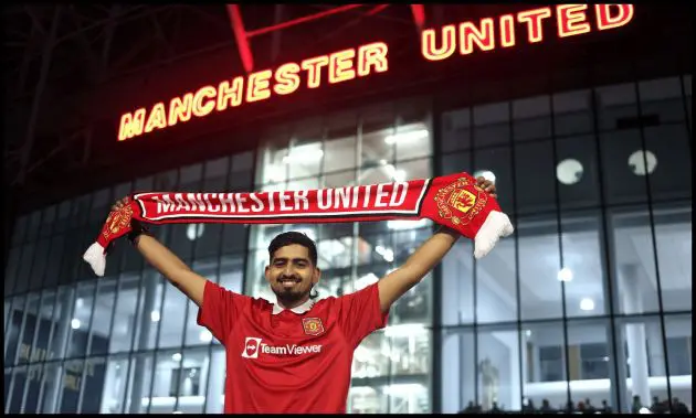 A Man United fan holds up a flag outside Old Trafford on matchday.