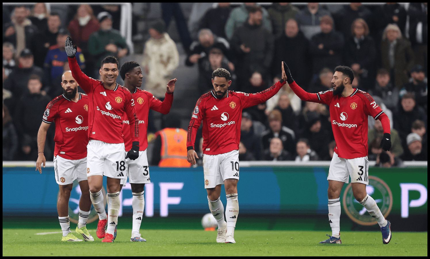 Man United players celebrate after Casemiro equalises vs Newcastle.