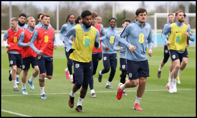 Marcus Rashford and Harry Maguire of England warm up during a training session at St Georges Park on March 24, 2026 in Burton-upon-Trent, England.