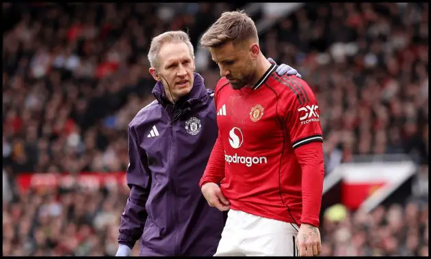 Luke Shaw leaves the pitch looking dejected after sustaining an injury.