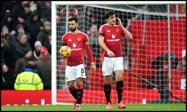 Harry Maguire and Bruno Fernandes side by side on the pitch