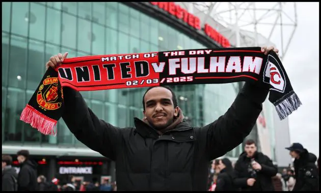 MANCHESTER, ENGLAND - MARCH 02: A general view as a fan of Manchester United holds up a half and half match day scarf outside the stadium prior to the Emirates FA Cup Fifth Round match between Manchester United and Fulham at Old Trafford on March 02, 2025 in Manchester, England.