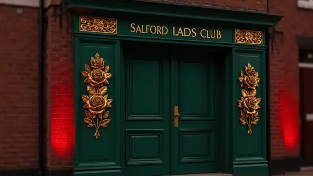Salford Lads Club entrance with gold Lancashire roses on green panels