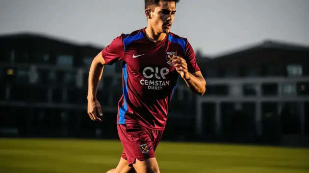 Young midfielder in West Ham kit during training session at Premier League facility