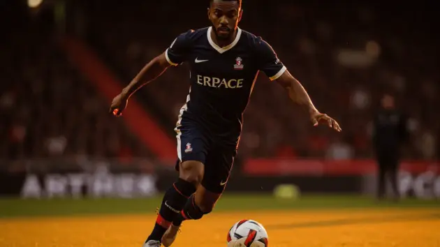 Midfielder in action on Premier League pitch during match play
