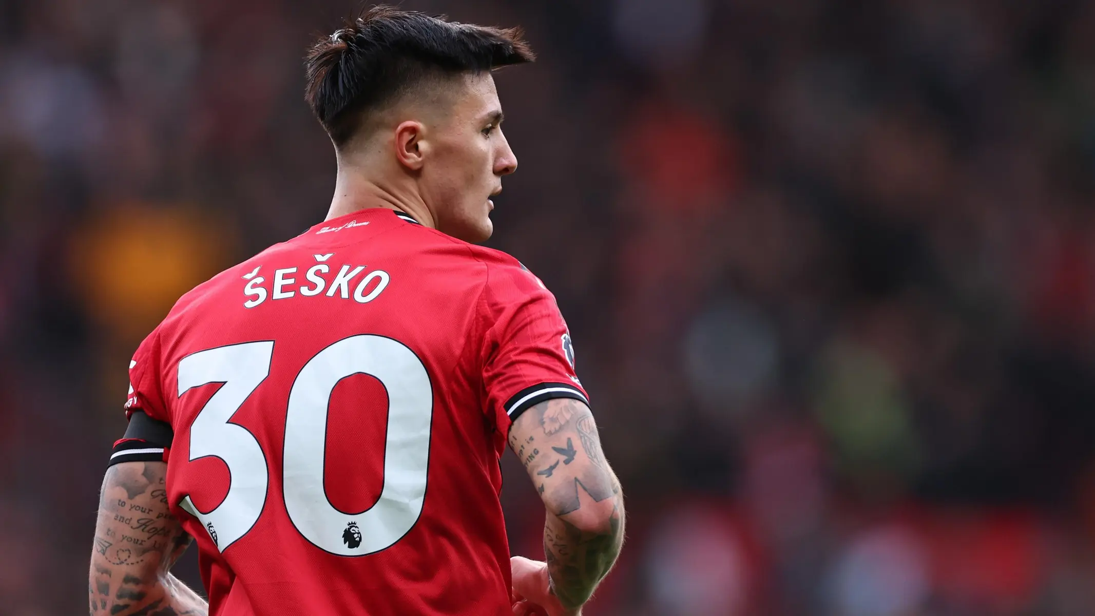Benjamin Sesko from behind wearing a red jersey with his name and number 30 on the back