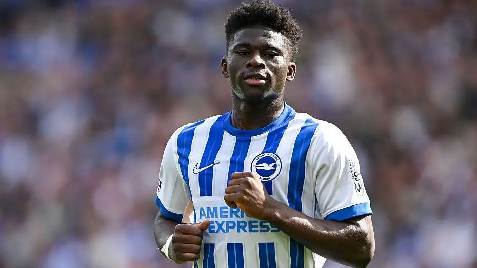 Carlos Baleba wearing a blue and white striped Brighton & Hove Albion jersey during a match