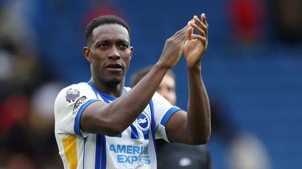Danny Welbeck in a Brighton & Hove Albion blue and white striped jersey clapping